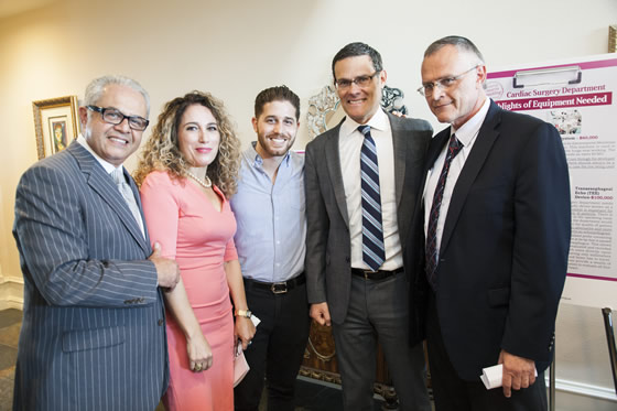 Guests beside a Rambam cardiac surgery equipment display