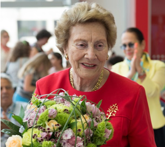 Ruth Rappaport holding a bouquet of flowers