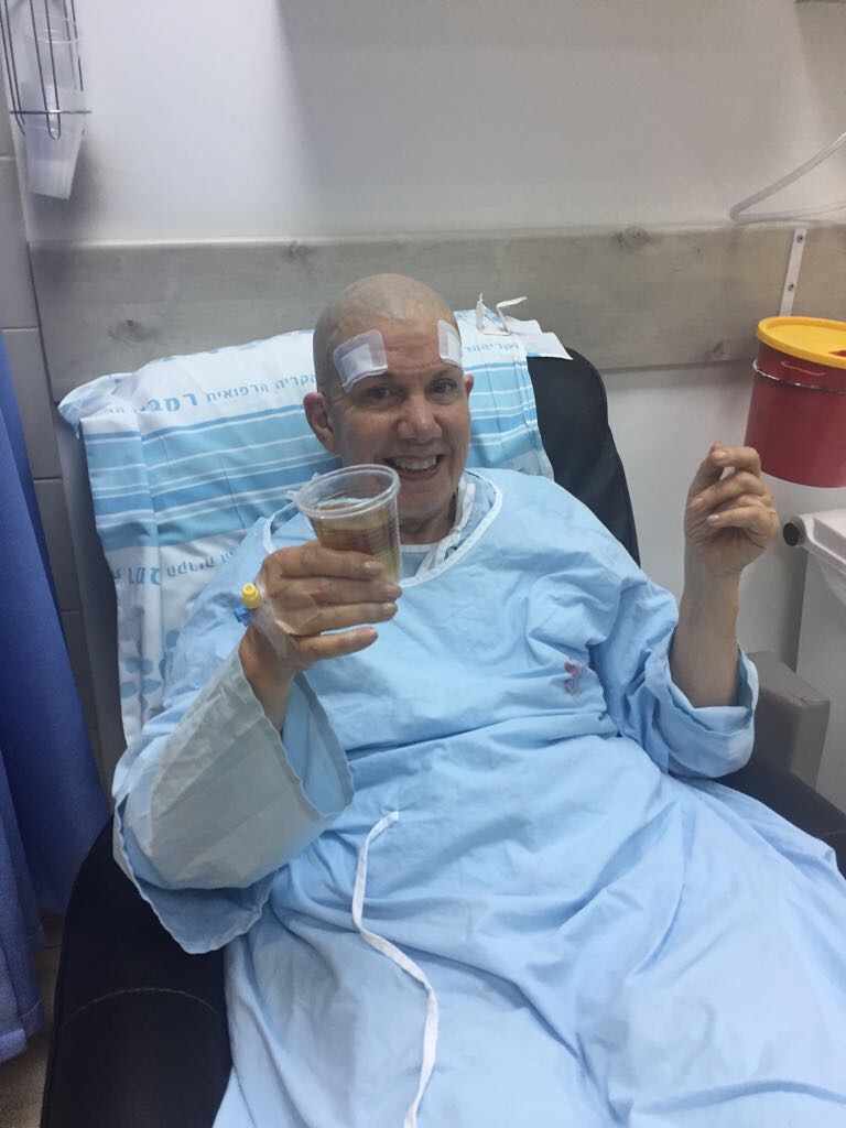 A smiling patient raising a toast after focused ultrasound treatment