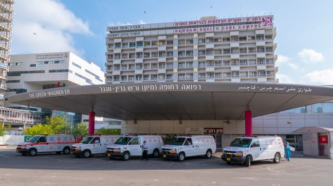Ambulances beneath the Green-Wagner Emergency Department canopy at Rambam