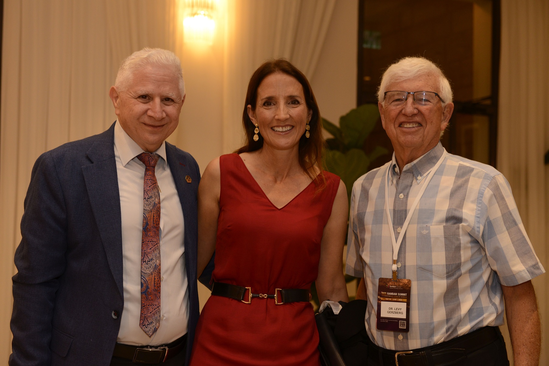 Dr. Levy Gerzberg with two guests at a Rambam Summit reception