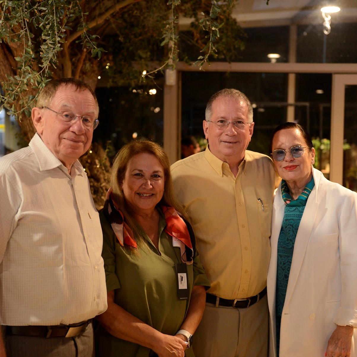 Four guests posing together at a Rambam evening event