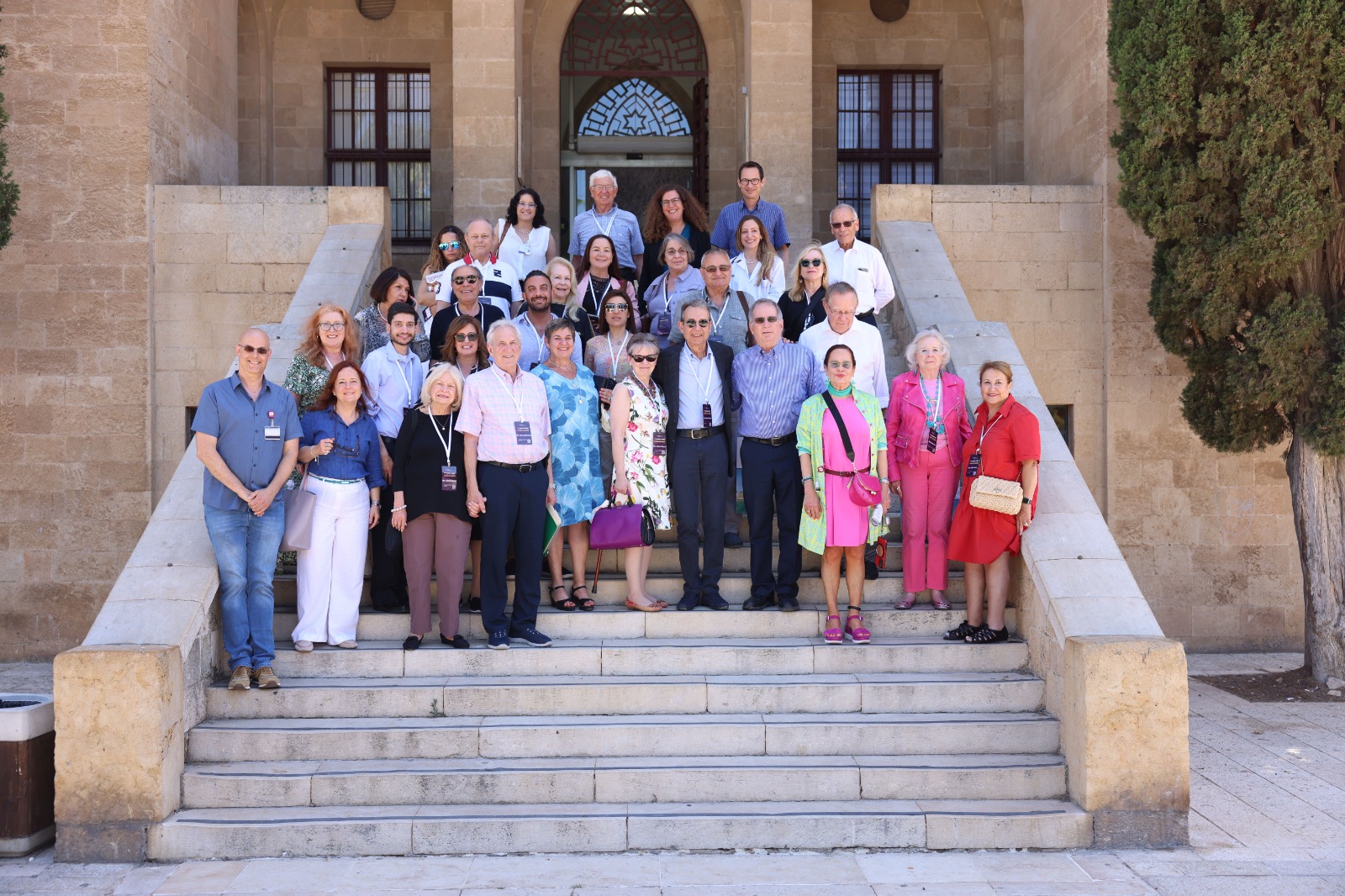 A delegation group on the steps of a historic Haifa building