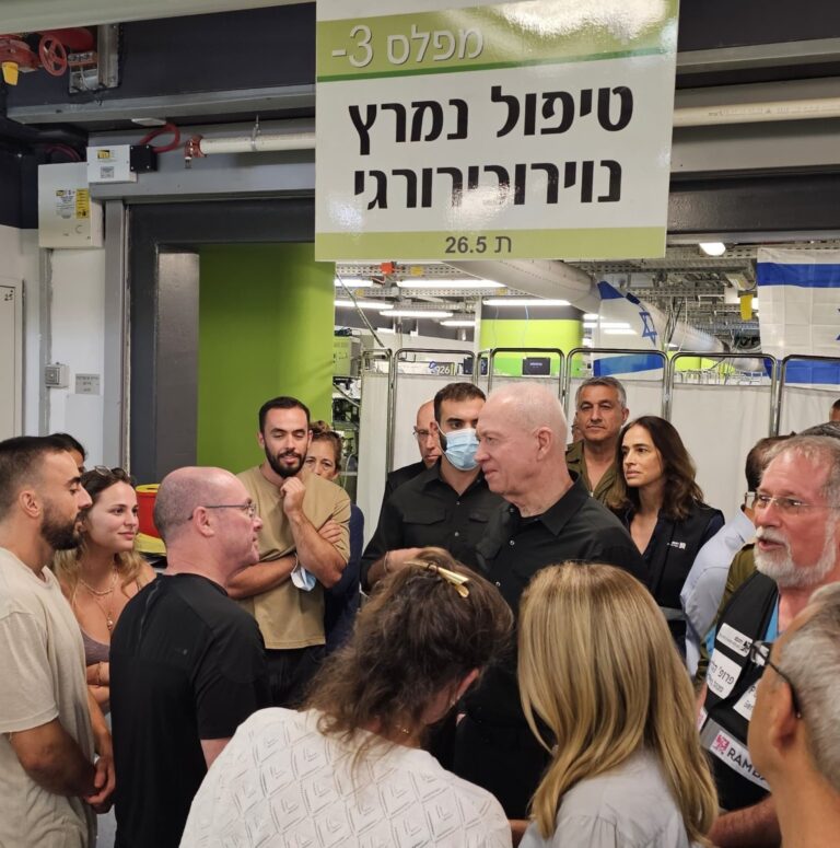 Yoav Gallant speaking with staff in the underground neurosurgical ICU