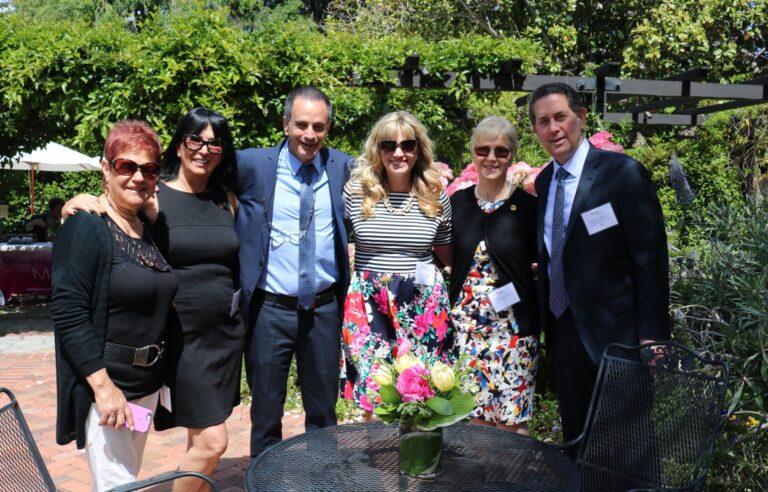 Six guests at a garden luncheon for Rambam supporters