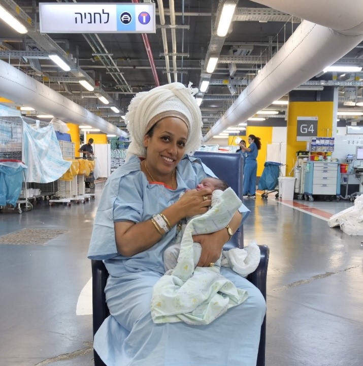 A mother cradling her newborn in the underground emergency hospital