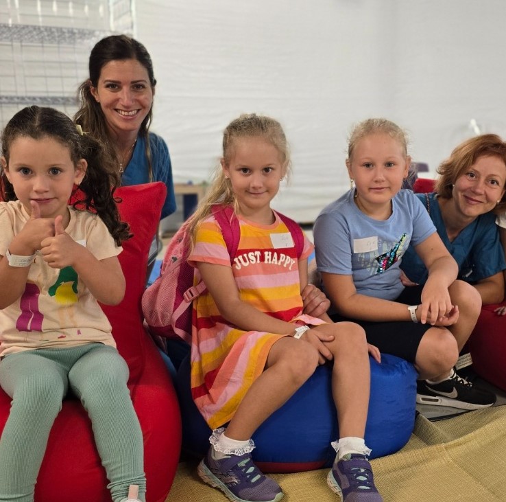 Children with caregivers in the underground hospital's daycare area