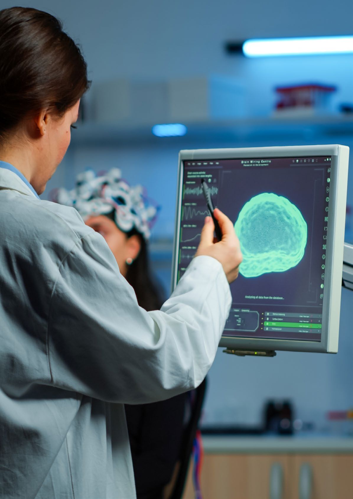 A Rambam researcher reviews brain activity with an EEG-capped patient