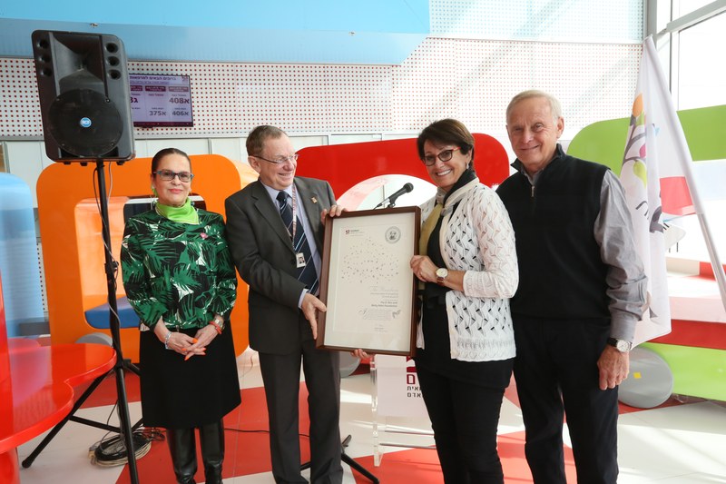 Andrea and Larry Wolfe of the D. Dan and Betty Kahn Foundation receiving a framed award at Rambam